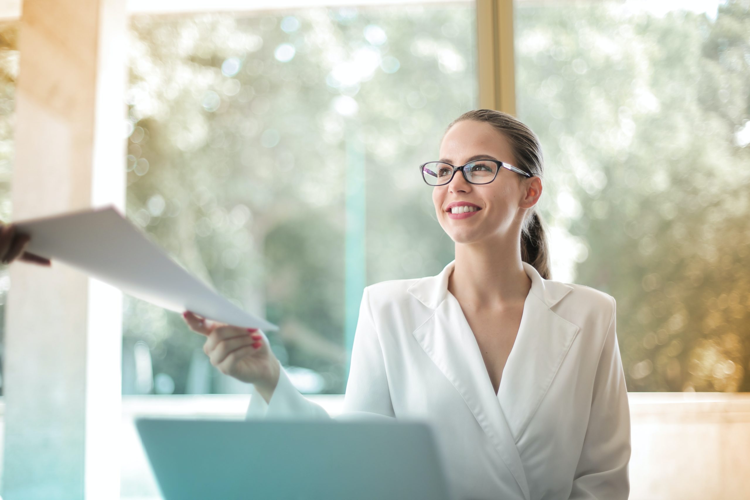 positive-businesswoman-doing-paperwork-in-office-3756678