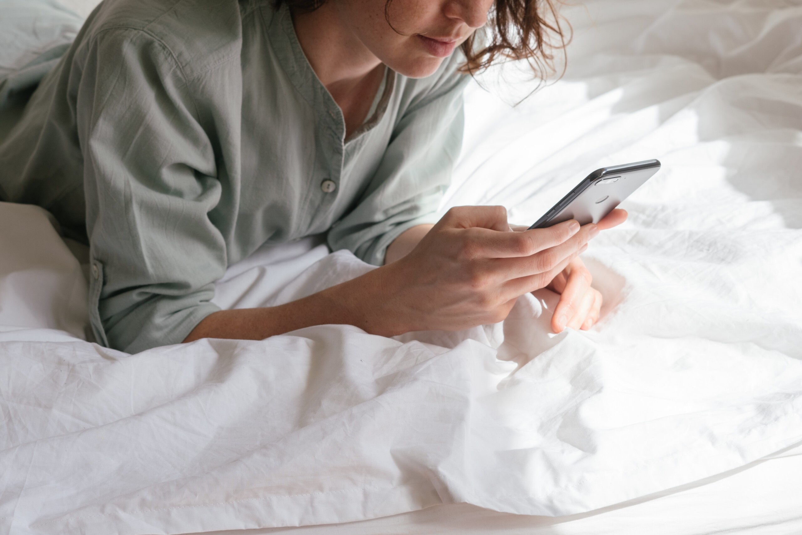 woman-using-smartphone-in-bed-3060643-1